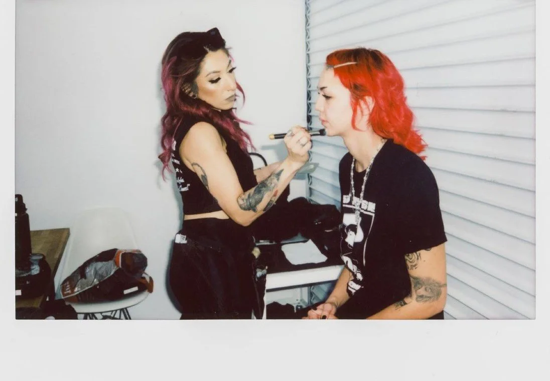 Andrea applying makeup on set
